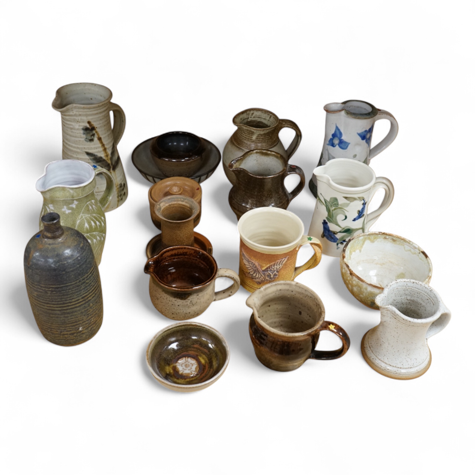 A large collection of studio pottery mugs bowls and jugs, tallest jug 21cm.